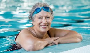 How can swimming improve balance and reduce risk of falling?